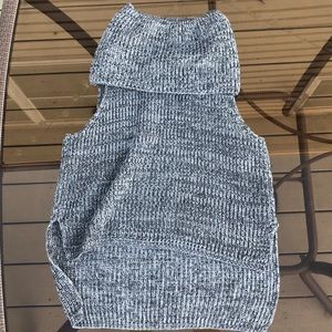 Knitted, soft grey sweater with no sleeves.